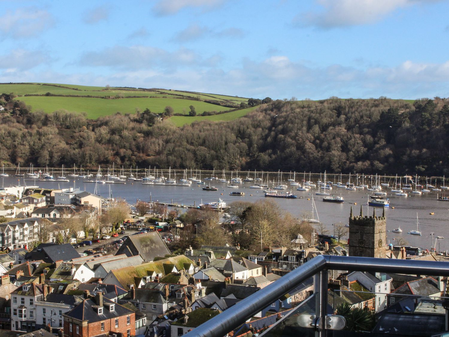 The view from Windwhistle's balcony over Dartmouth rooftops, boats and the River Dart